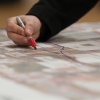 Belk Forum attendee traces his route through the space on a map