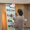 Attendee places a sticker on the movable seating option on the feedback board 